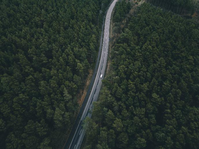 birds eye photography of white vehicle on road